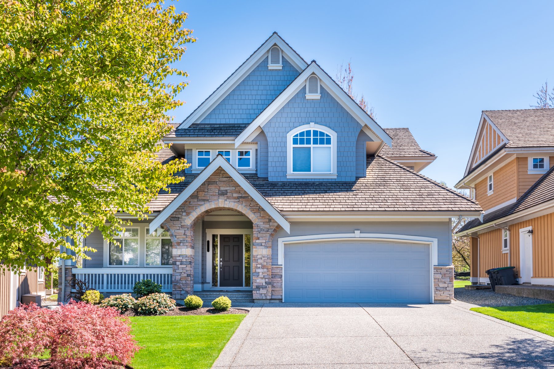 A sunlit suburban home with a welcoming front entrance